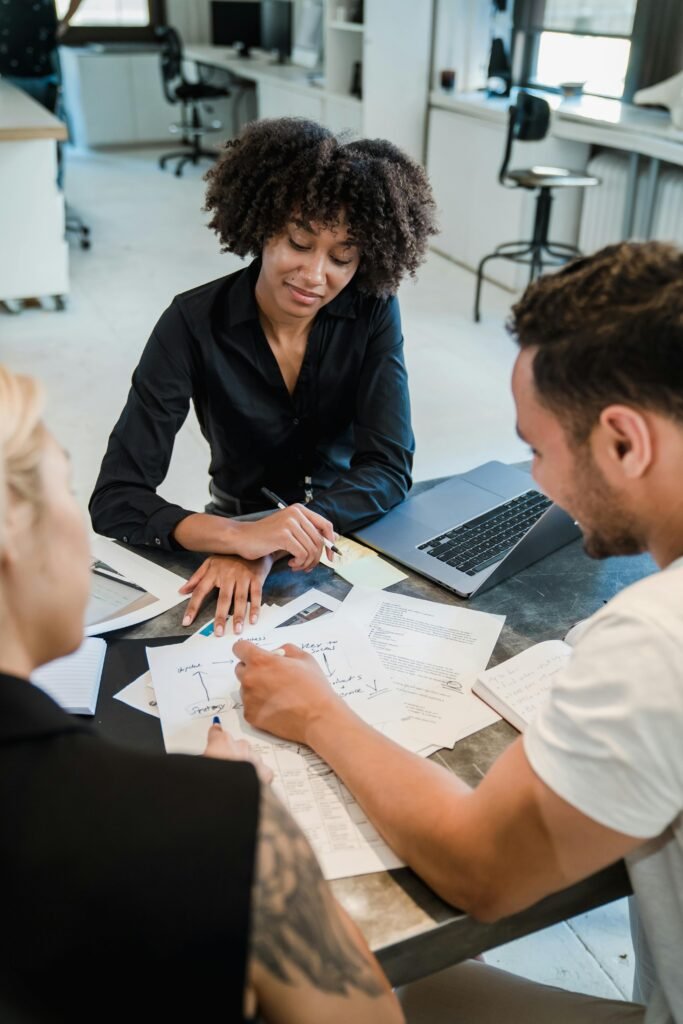 A diverse team reviewing documents during a business meeting in a modern office.
